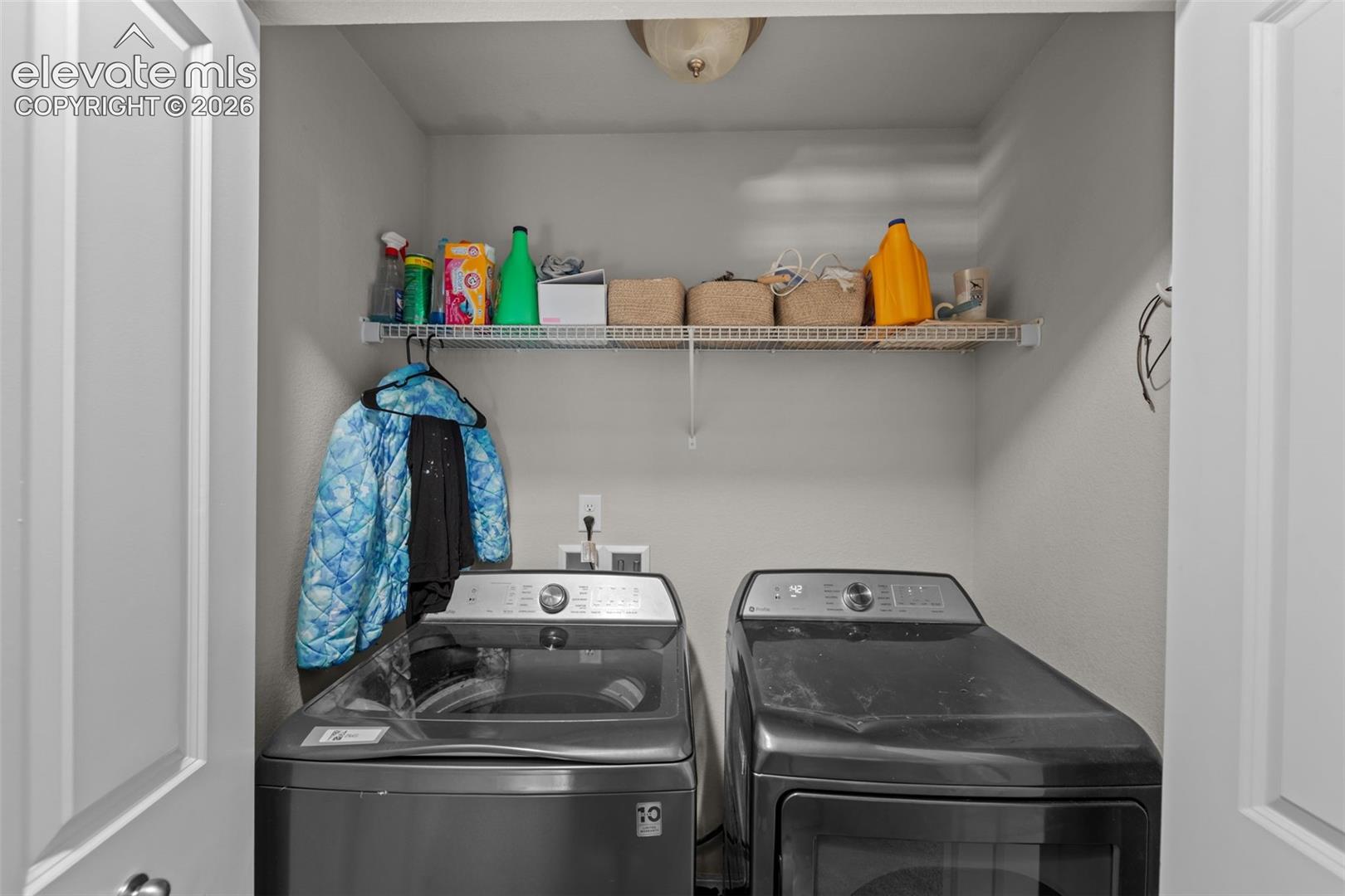 Dedicated laundry area with a wire storage shelf