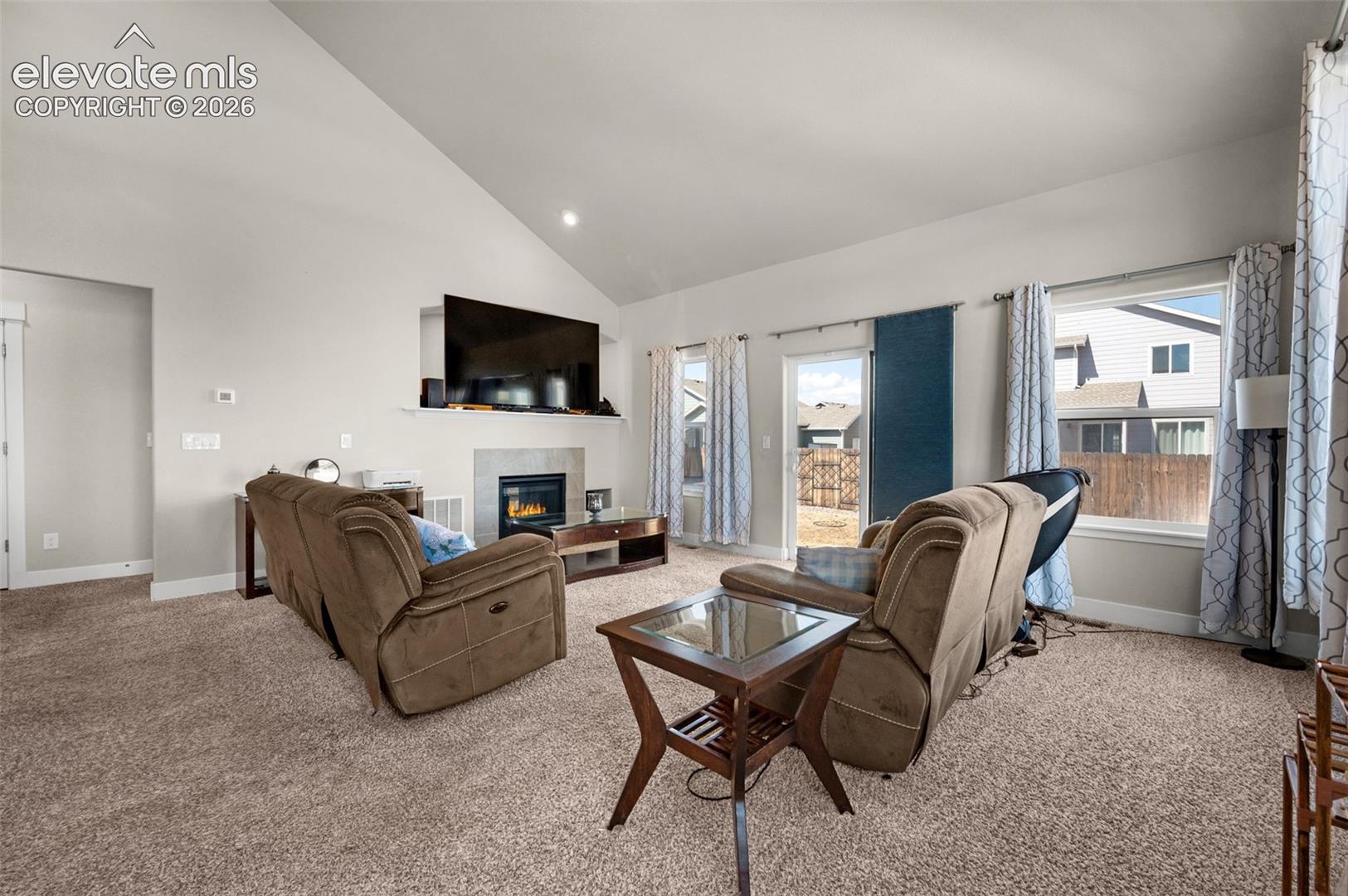 Living room has patio door that leads to patio in fenced back yard