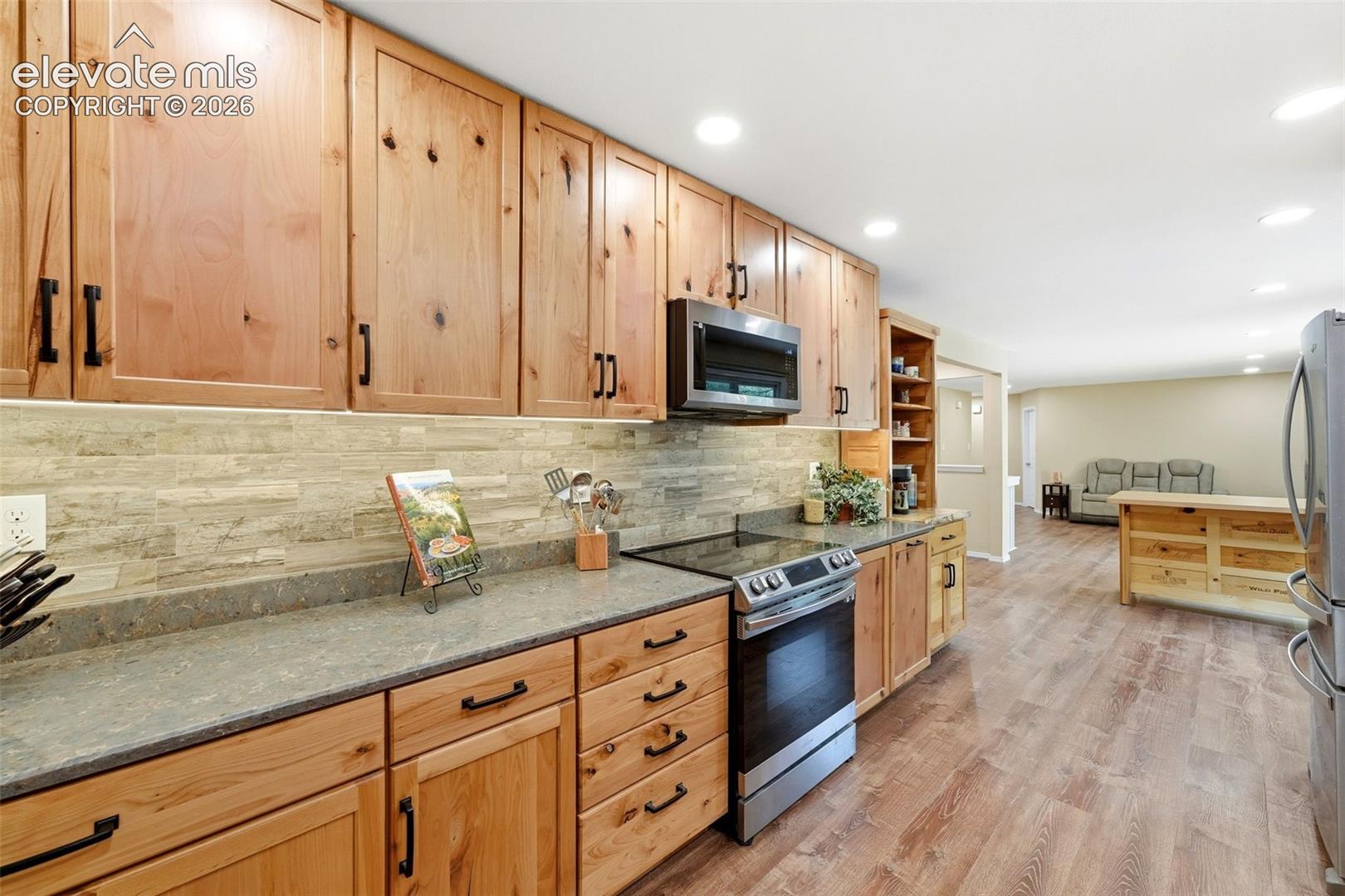 Granite countertops and stacked tile backsplash