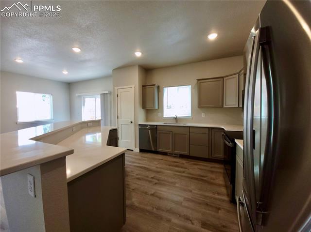 Kitchen features 30" upper cabinetry, pantry, and stainless steel undermount sink