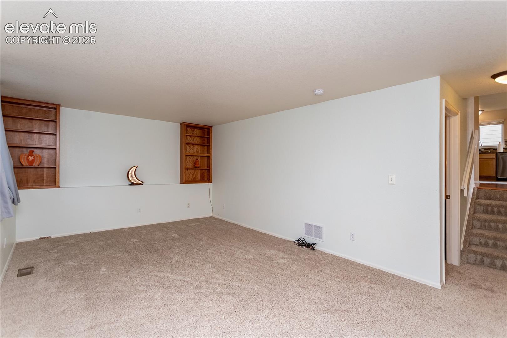 Lower level family room.  Stairs to the main level to the right.