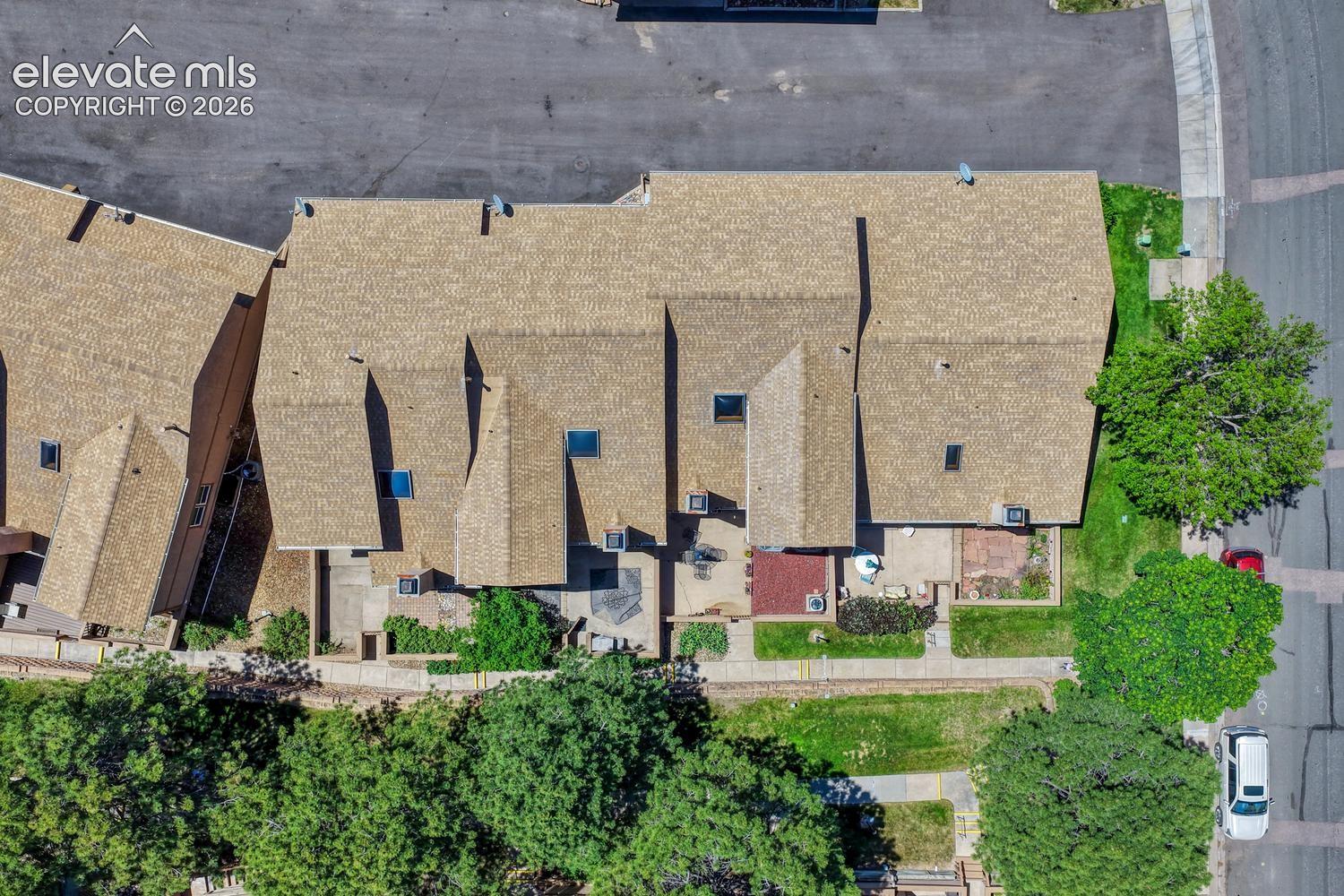 Aerial view of complex and tree-line walkway.
