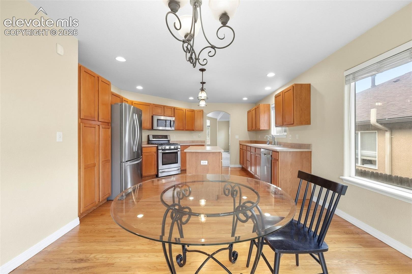 Gleaming Hardwood Flooring through Kitchen and Dining Area