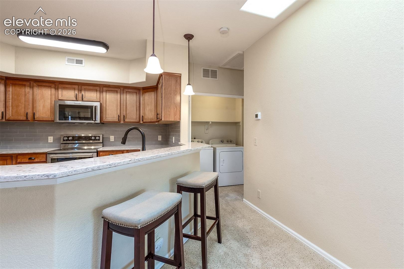Laundry conveniently located just around the corner from the kitchen, next to the 2nd bedroom and bathroom