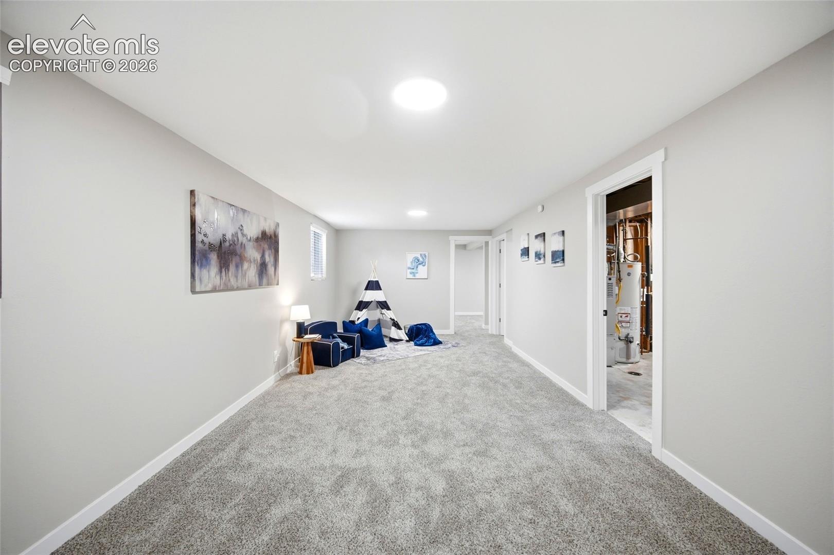 Expansive carpeted area with neutral wall finishes and recessed lighting