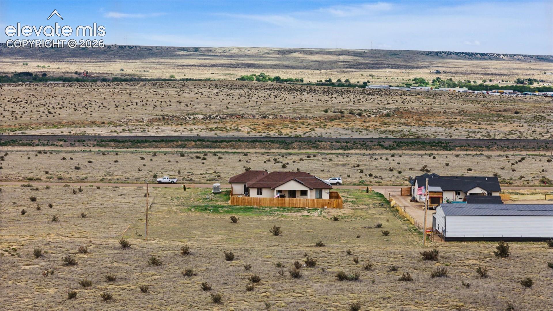Ranch-style residence featuring an earth-toned exterior and a brown shingle roof