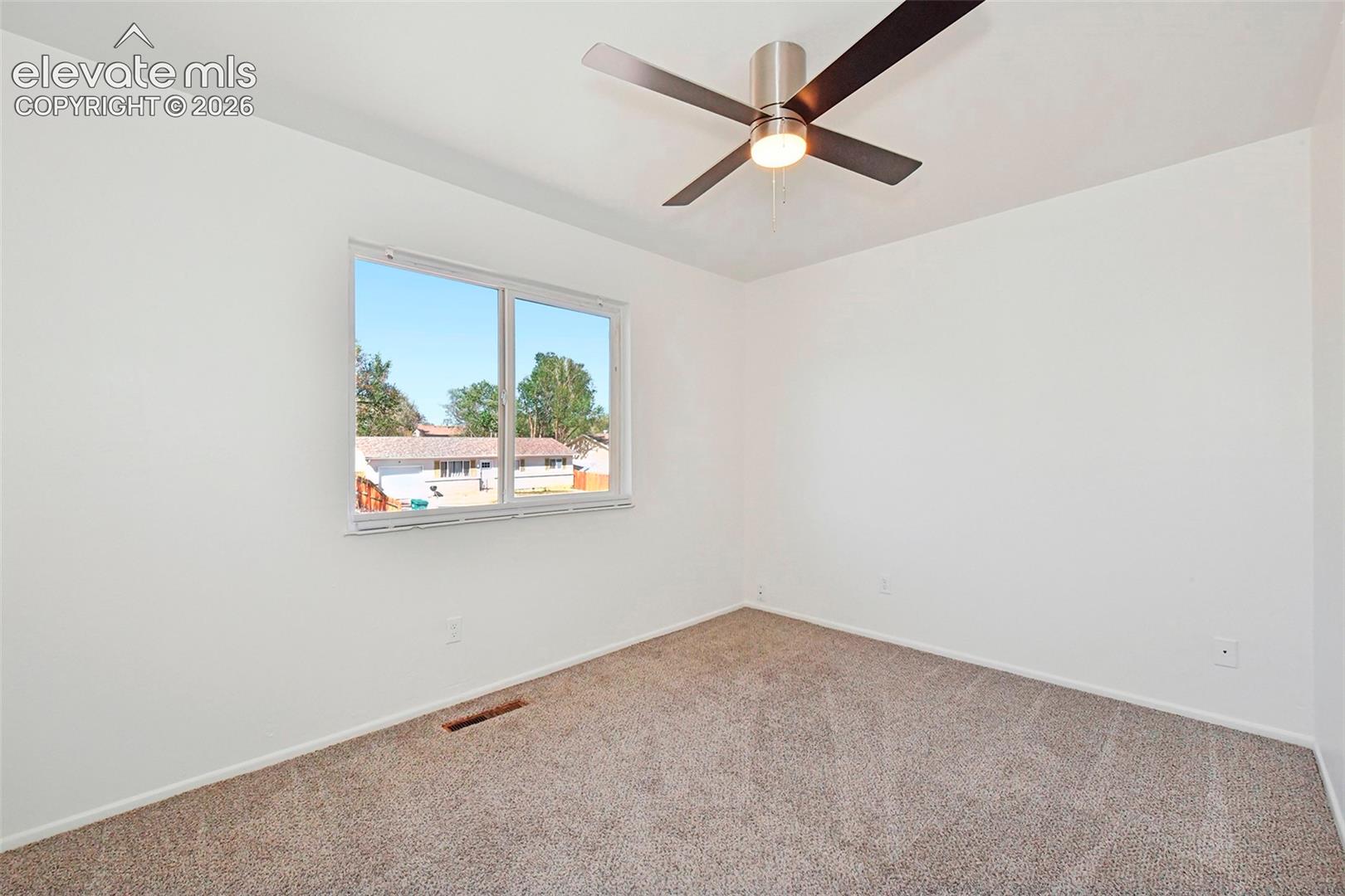 Upper front facing bedroom with new ceiling fan