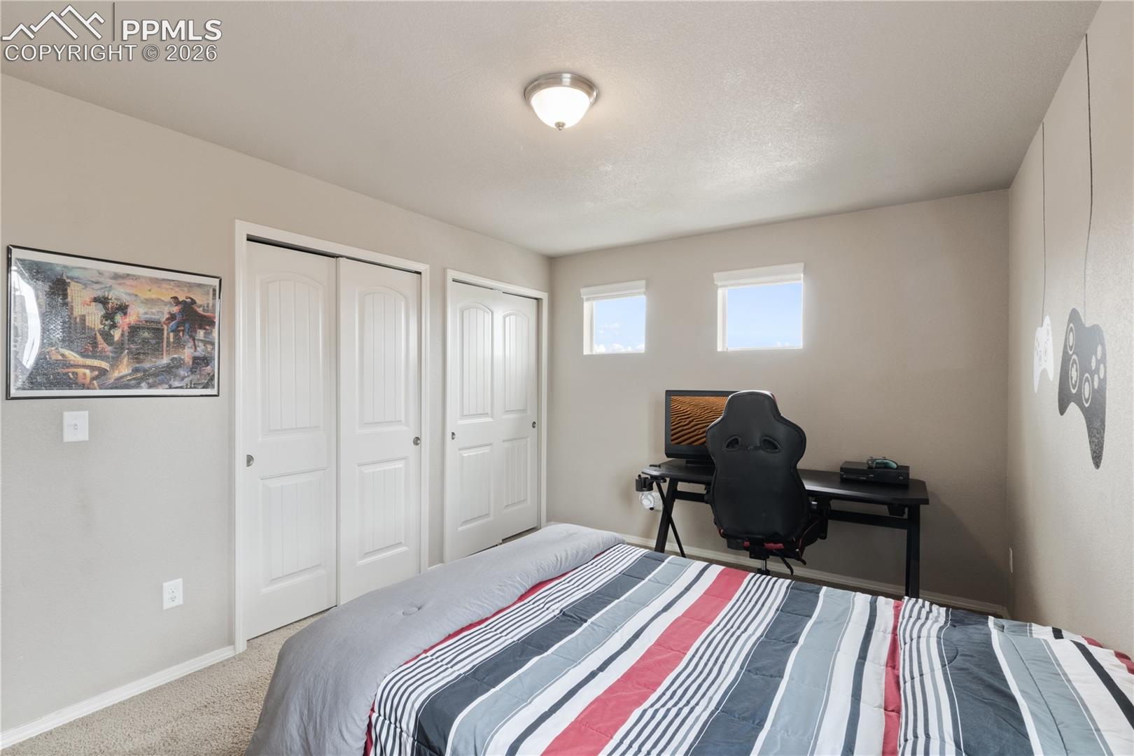 Bedroom featuring carpet floors and multiple closets