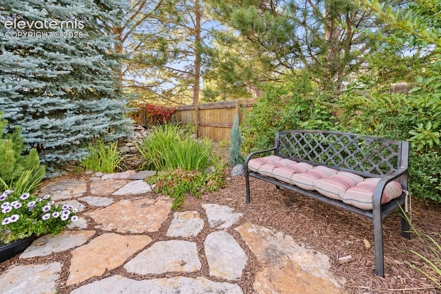 Flagstone path with sitting area amongst the trees.