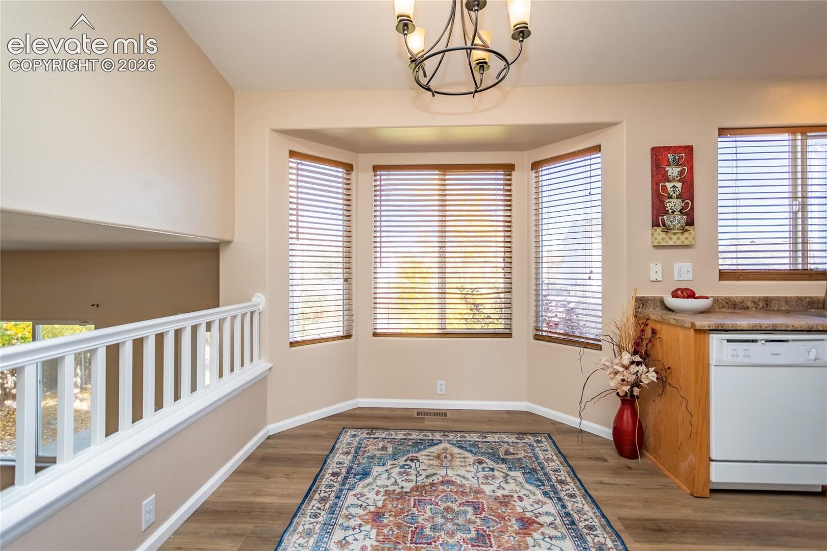 Dine in style in the bright eating area featuring a classic bay window with wood blinds