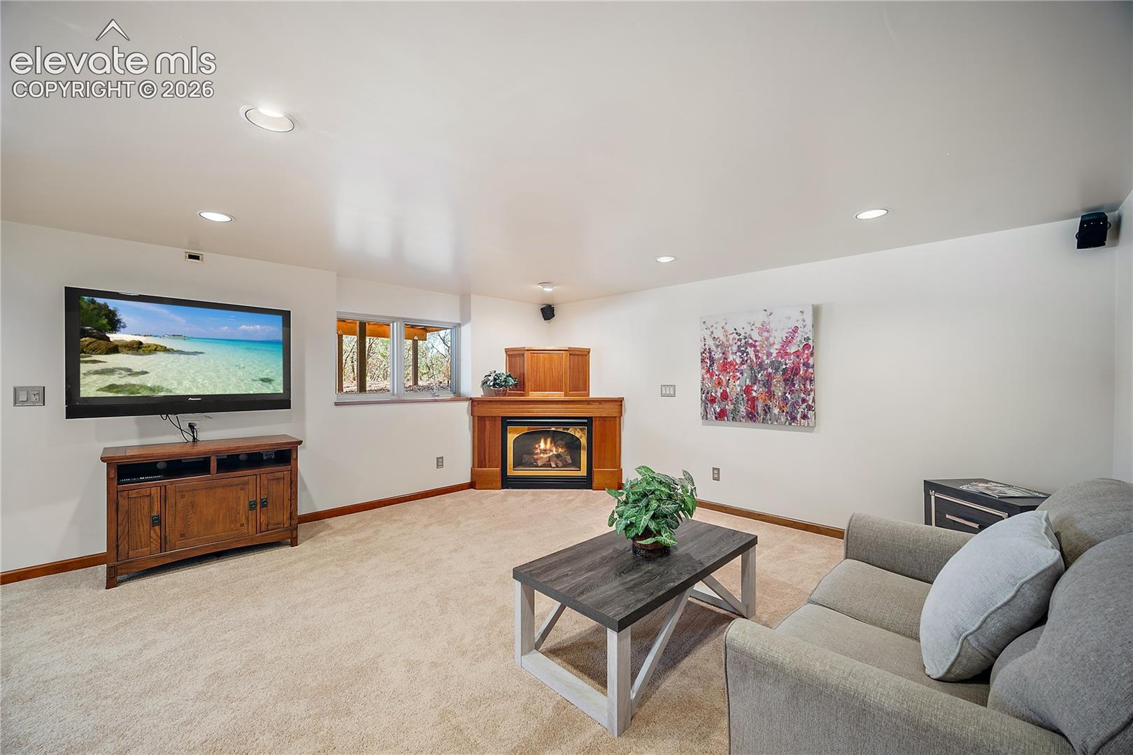 Family room with corner gas fireplace. 