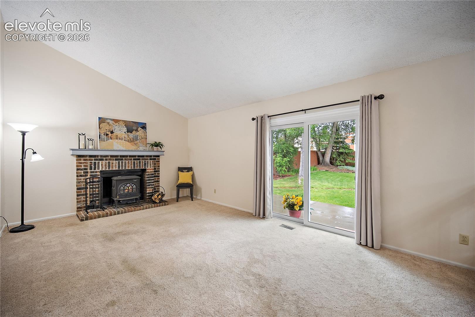 Family room features carpet. Fireplace and walks out to back yard.