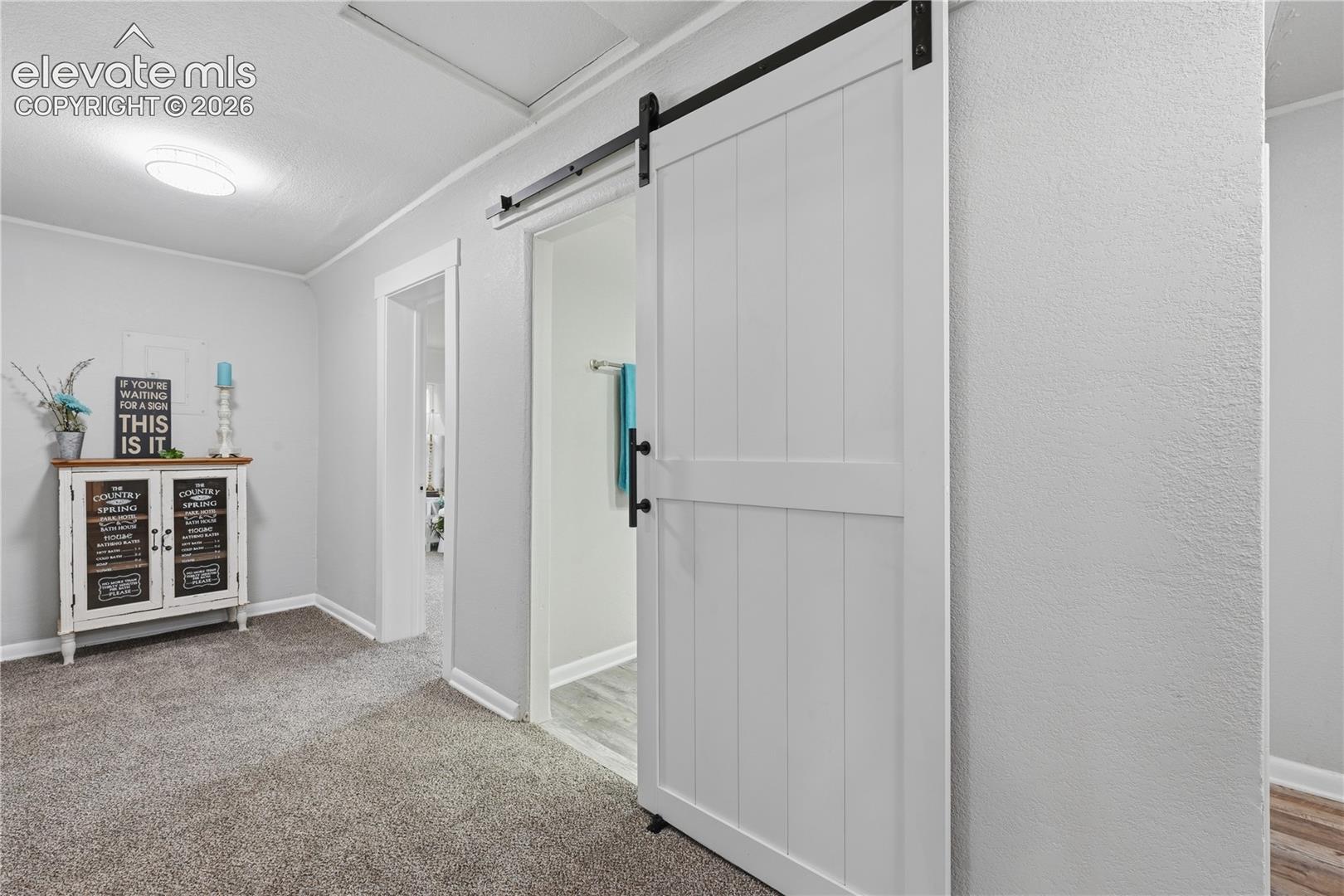 The barn door entrance to the hall bathroom.