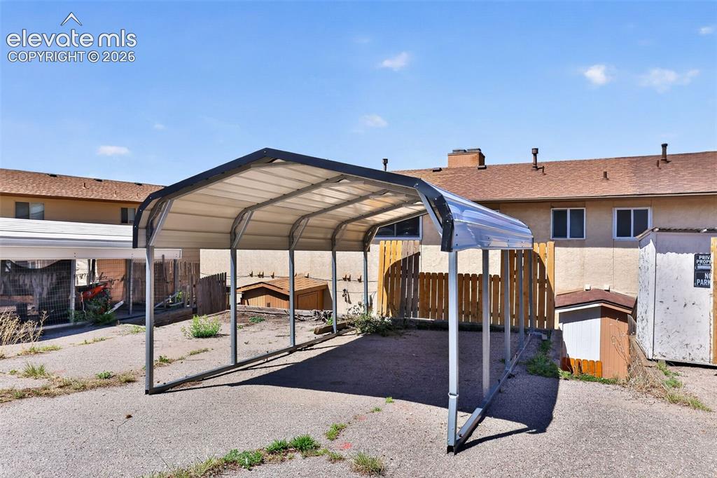 Covered parking structure with a metal frame and corrugated roof