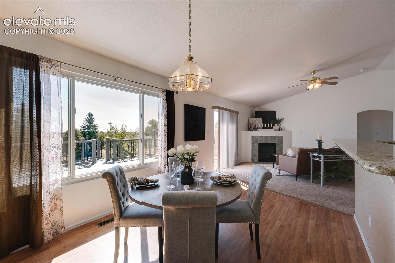 This inviting dining area is bathed in natural light and opens effortlessly to the living room and deck, creating the perfect indoor-outdoor flow.