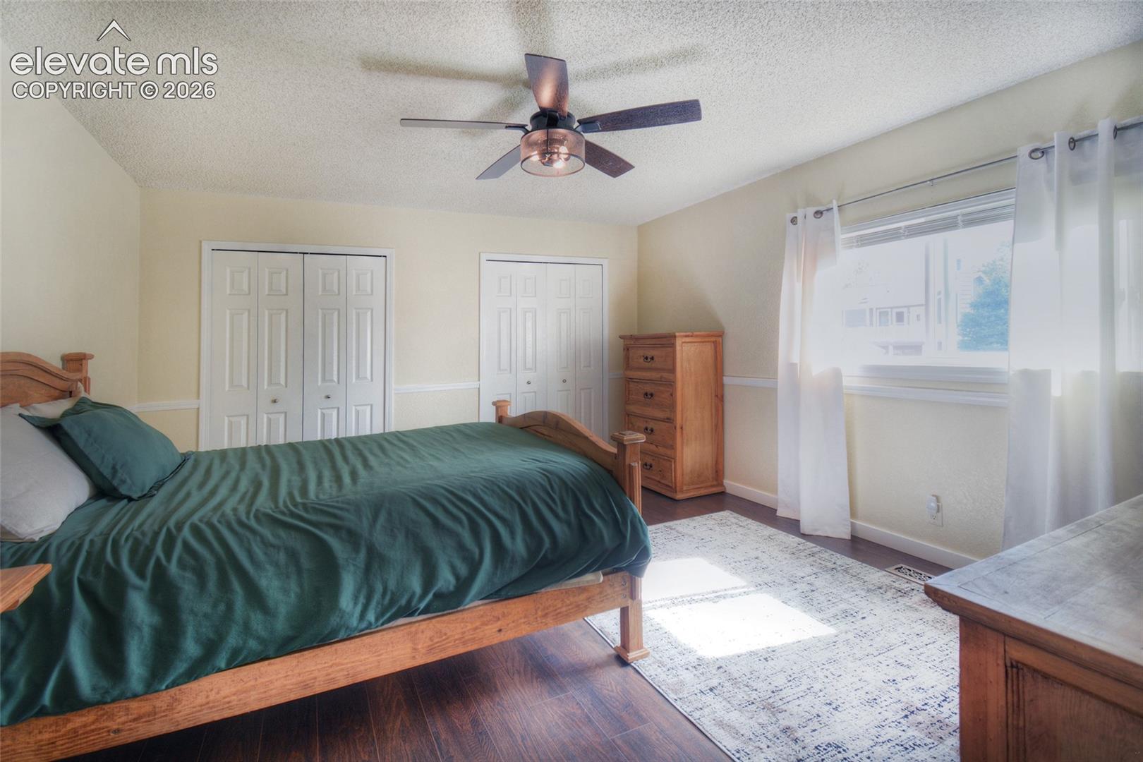 3rd upper level bedroom with LVP flooring and decorative ceiling fan with lights.