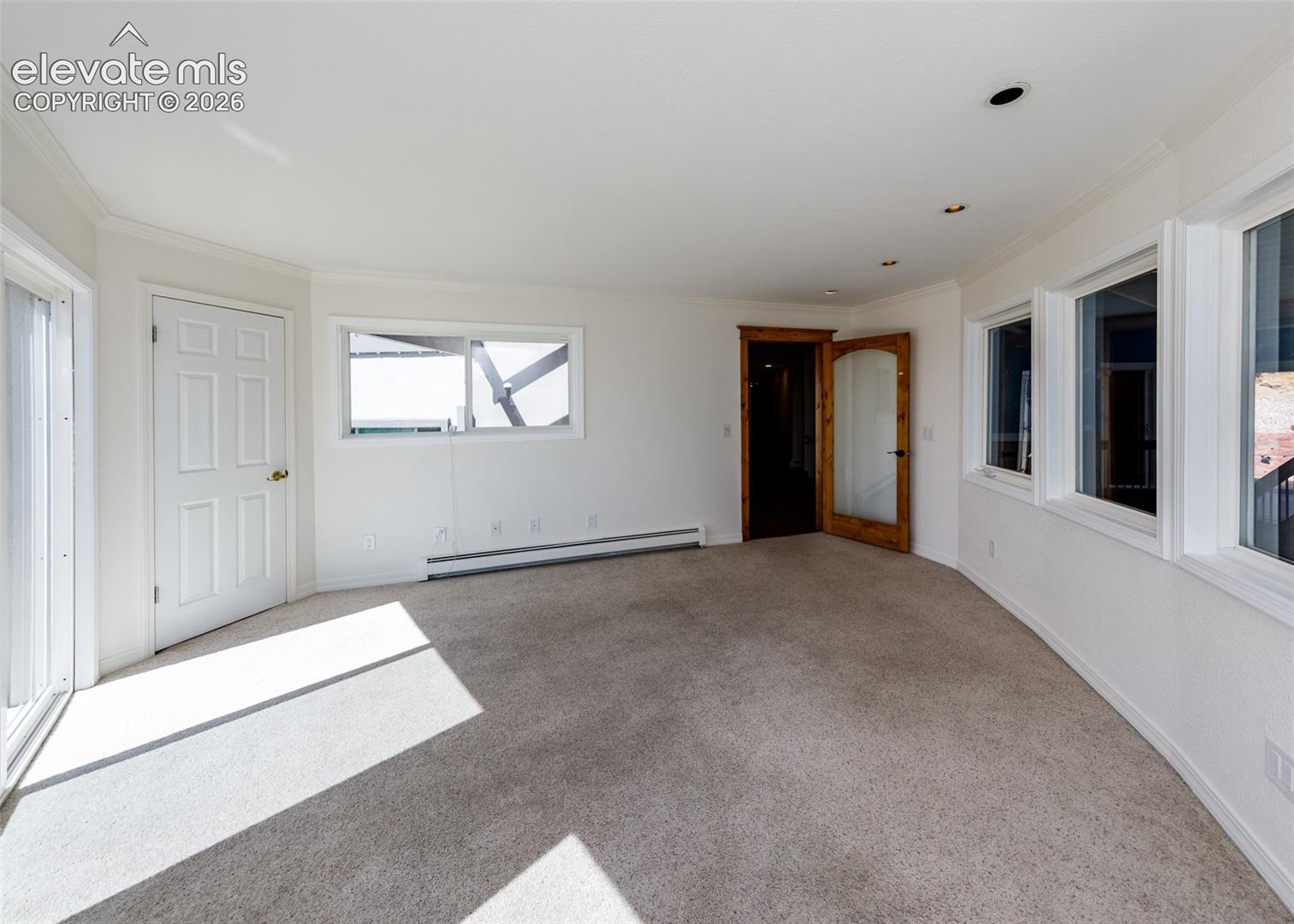 Workout room overlooks the pool area and mountain views