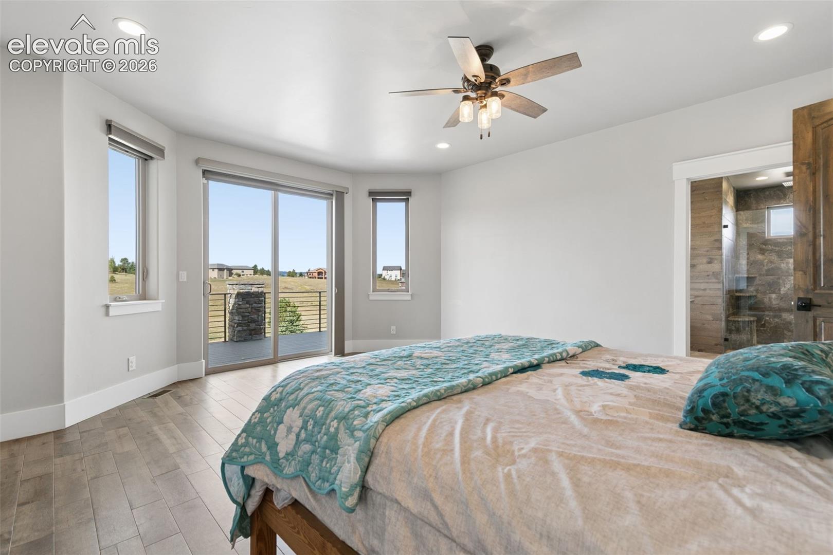 Wood-finish flooring, recessed lighting, and a ceiling fan with integrated light fixture