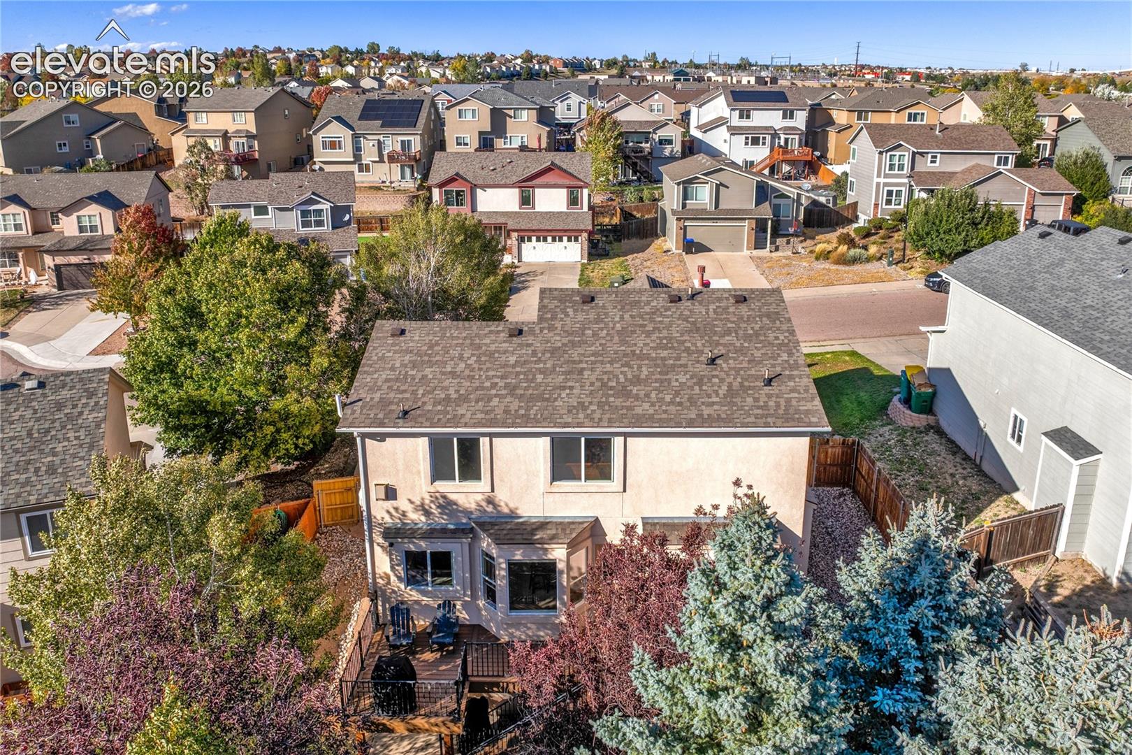 The home's 6,044-square-foot lot includes a fenced backyard, mature trees + multiple outdoor living areas, with a composite deck above the finished walk-out basement.