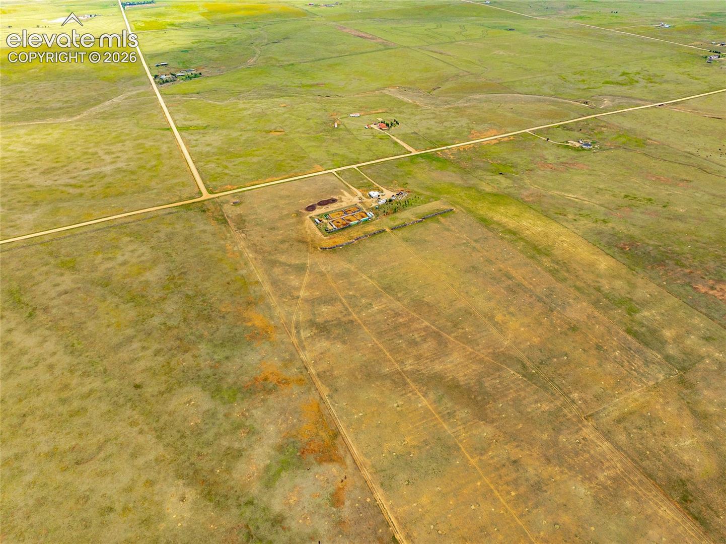 Expansive rural acreage featuring home, open pastureland, and direct dirt road access