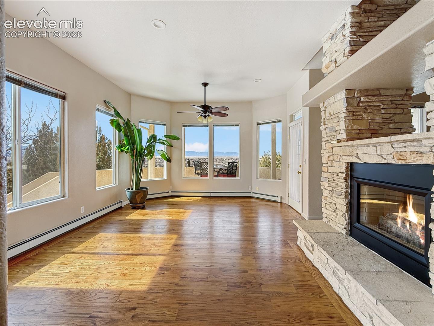 Beautiful formal dining area with bay windows and fireplace as well as an entrance to the balcony