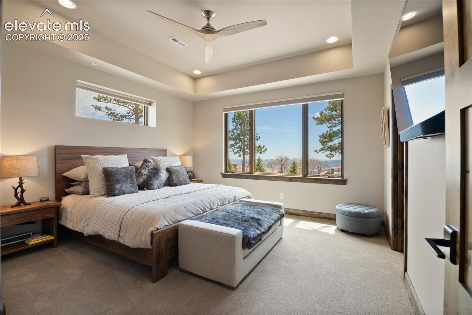 Guests get the VIP treatment in this private lower-level suite, featuring a recessed ceiling detail, mountain views from bed, and tucked-away comfort that feels like its own retreat.
