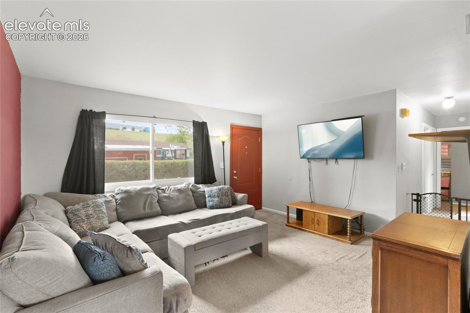 Living room with plenty natural light through new front windows