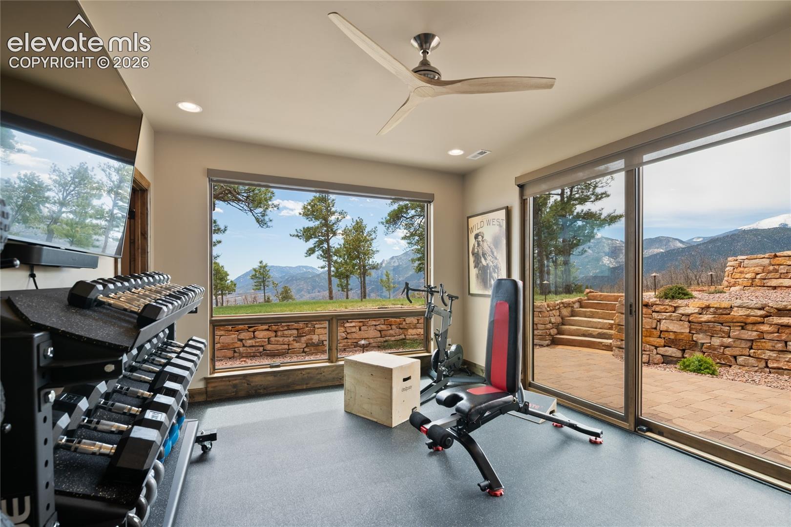 Why drive to the gym when this is the view? Lower-level fitness room with walk-out access, panoramic mountain views, and the flexibility to convert to a 4th bedroom.