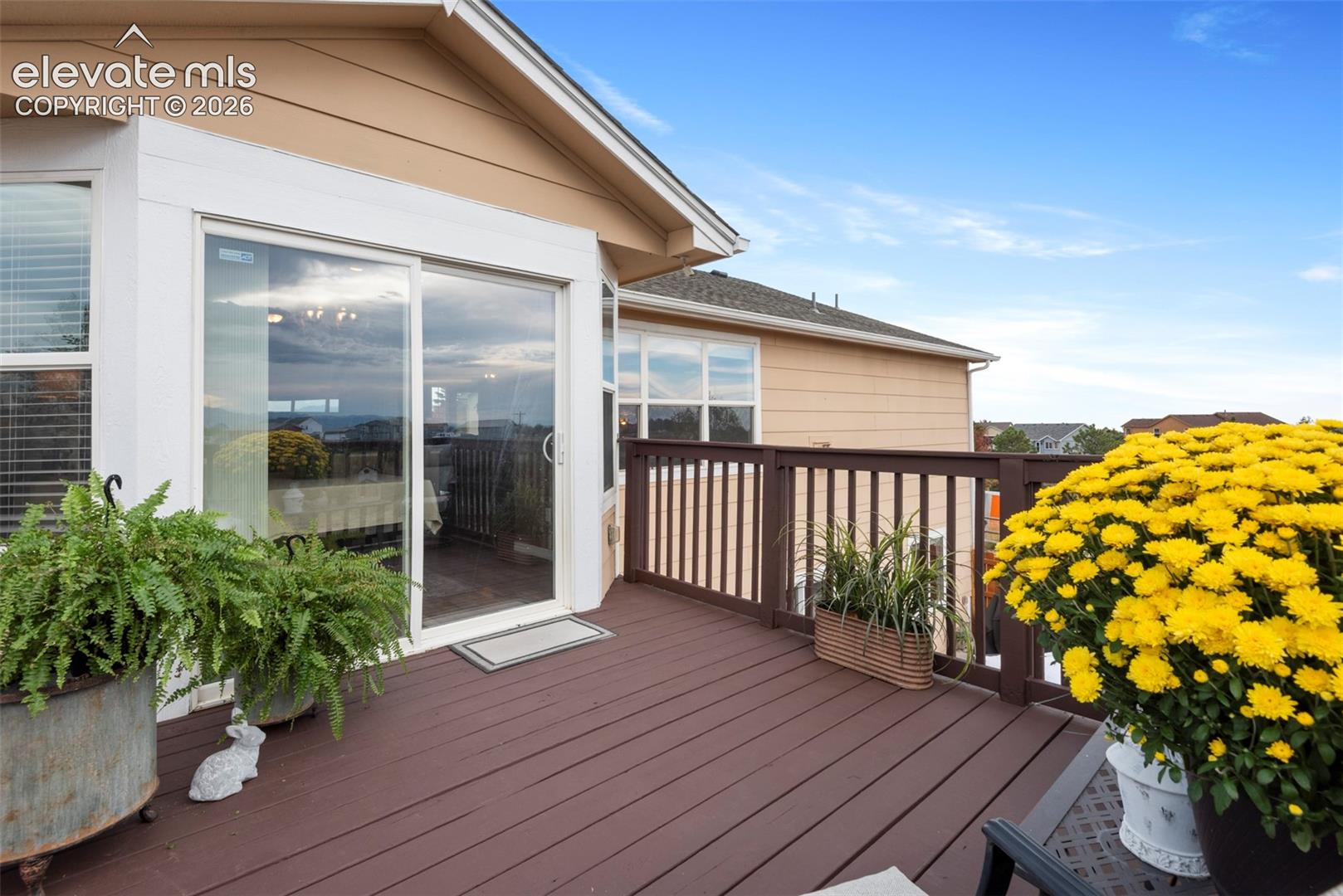 Elevated Deck Featuring Beautiful Front Range Mountain Views, Freshly Painted Wood Deck, and Large Sliding Glass Door Entry