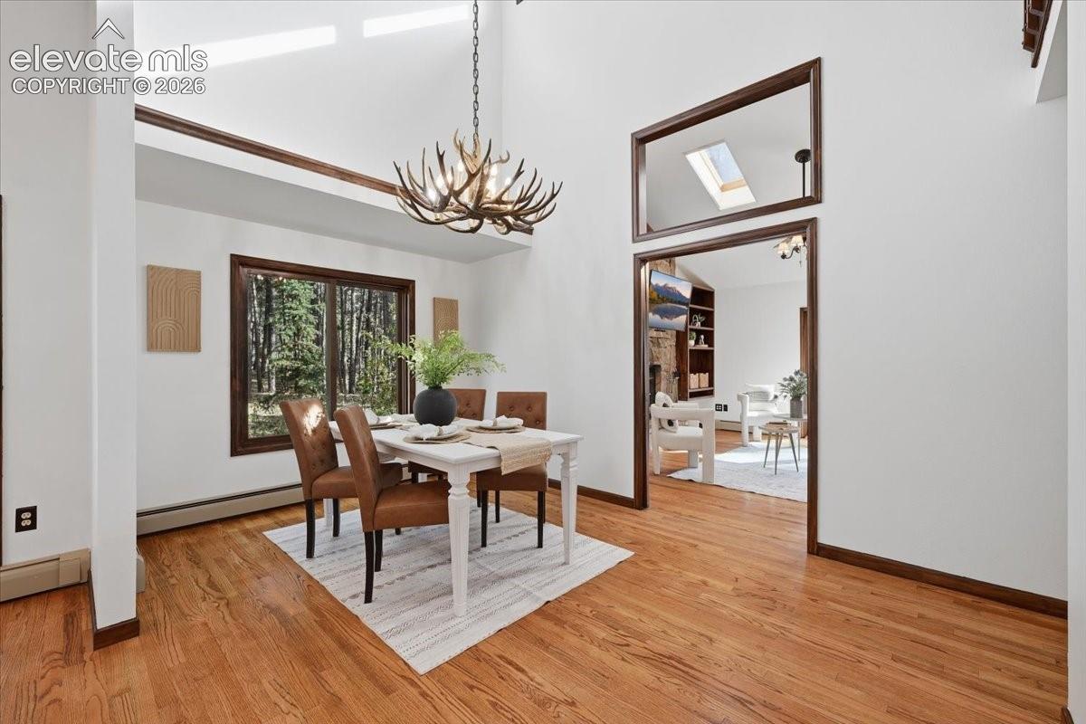 Hardwood flooring throughout, recessed ceiling lighting, wood staircase with carpeted treads, and wood-framed doorways