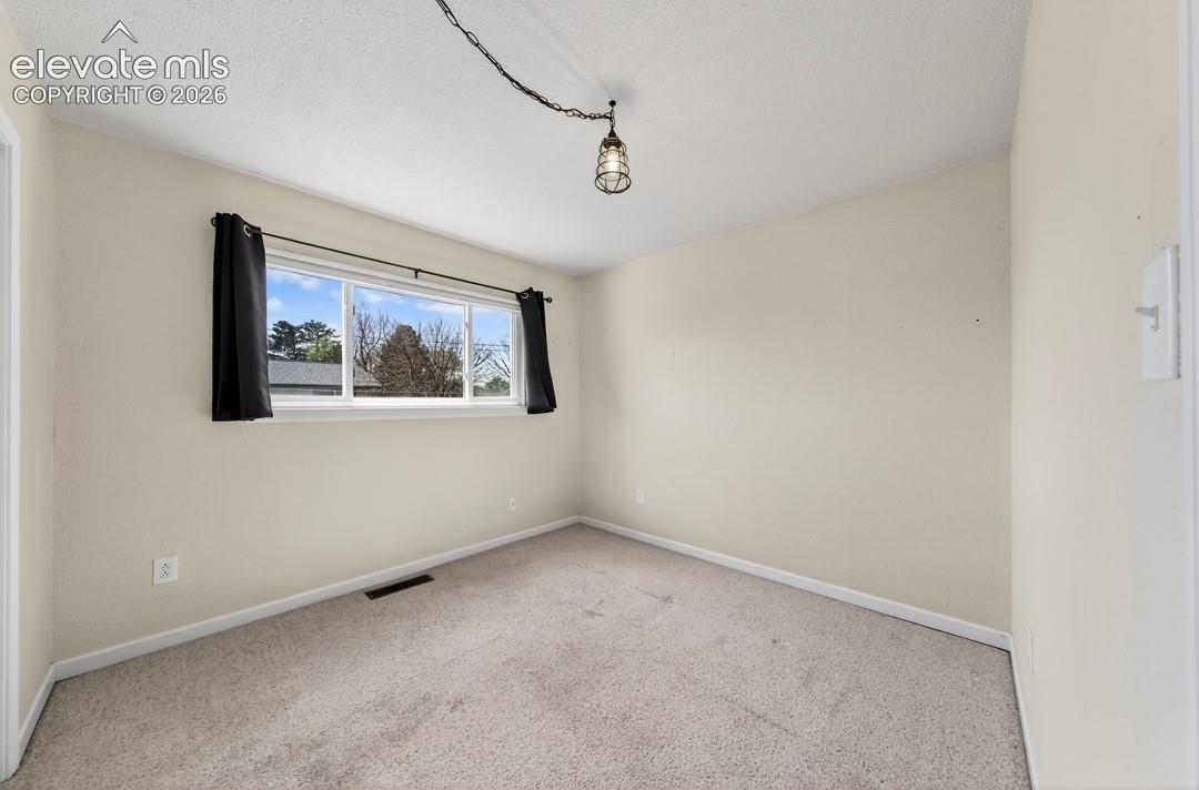 Recessed window with white trim, light-colored walls, and neutral carpeting
