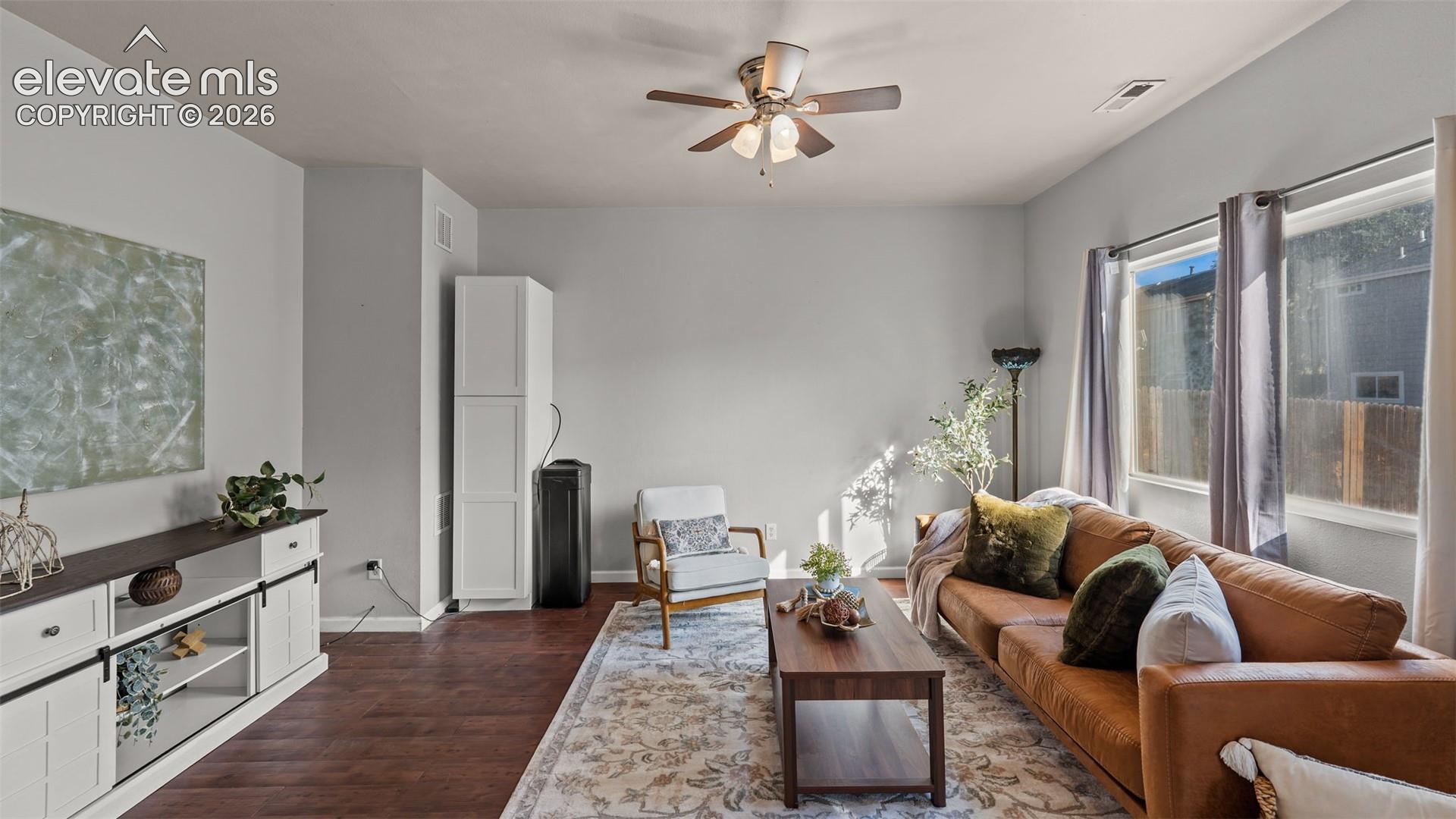Wood-finish flooring, ceiling fan, and multiple windows