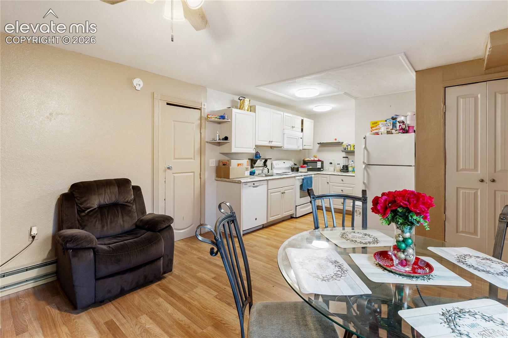 Kitchen featuring white cabinetry, wood-finish flooring, and recessed ceiling lighting