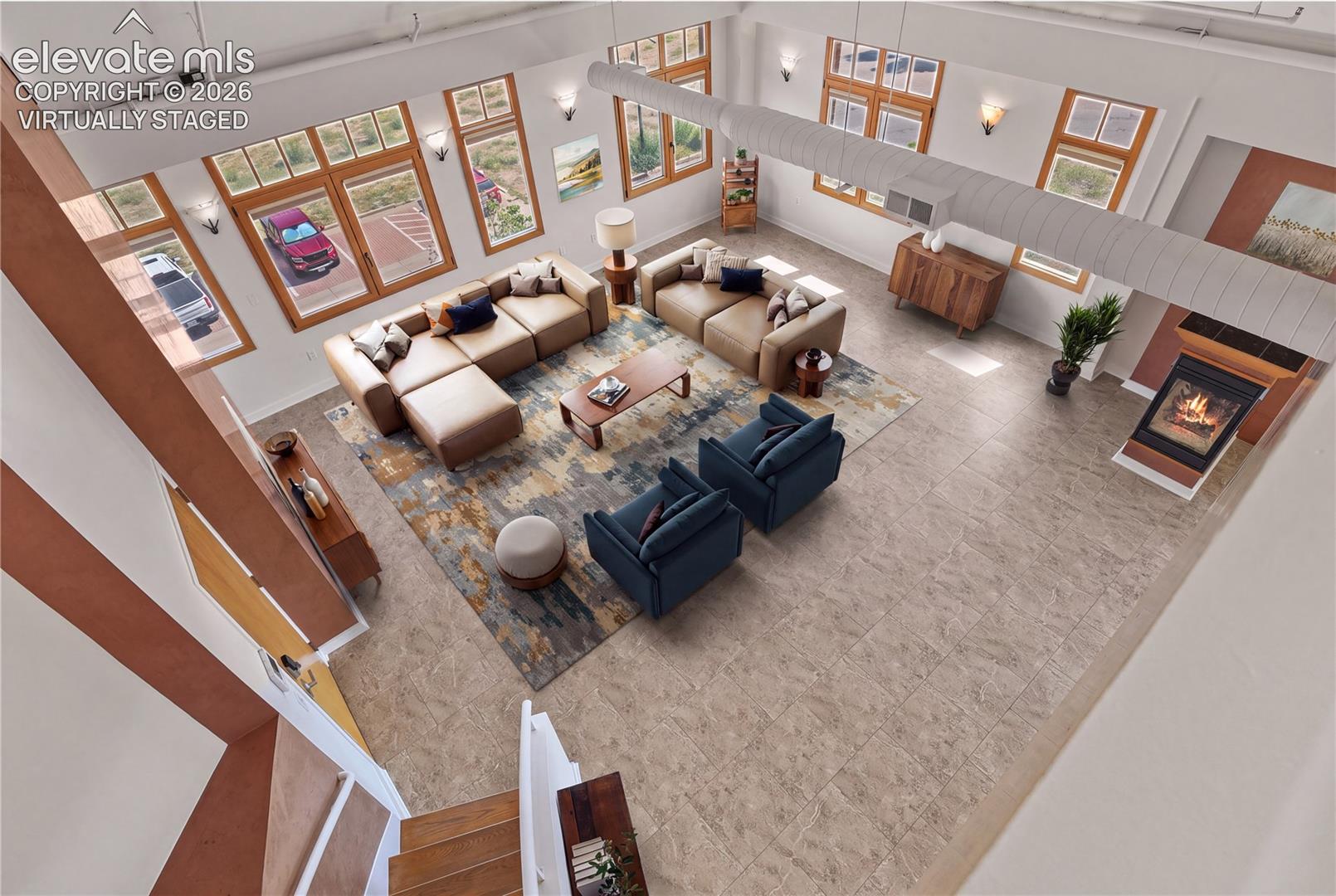 View of the expansive great room from the upper loft space. Virtually Staged