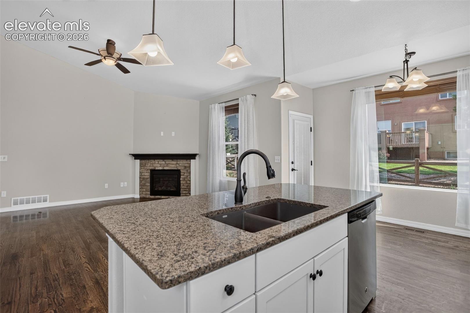 Kitchen island with stone-finish countertop and undermount sink