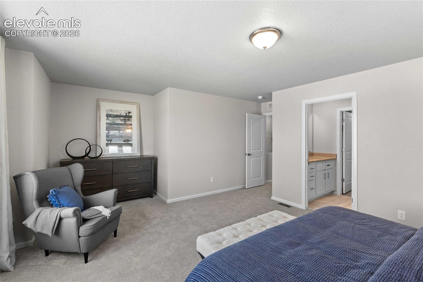 Neutral-toned wall paint, plush carpeting, a flush-mount overhead light fixture, and a multi-panel interior door
*photos of a model home*