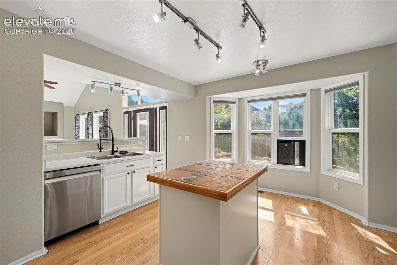 White cabinetry and stainless steel appliances