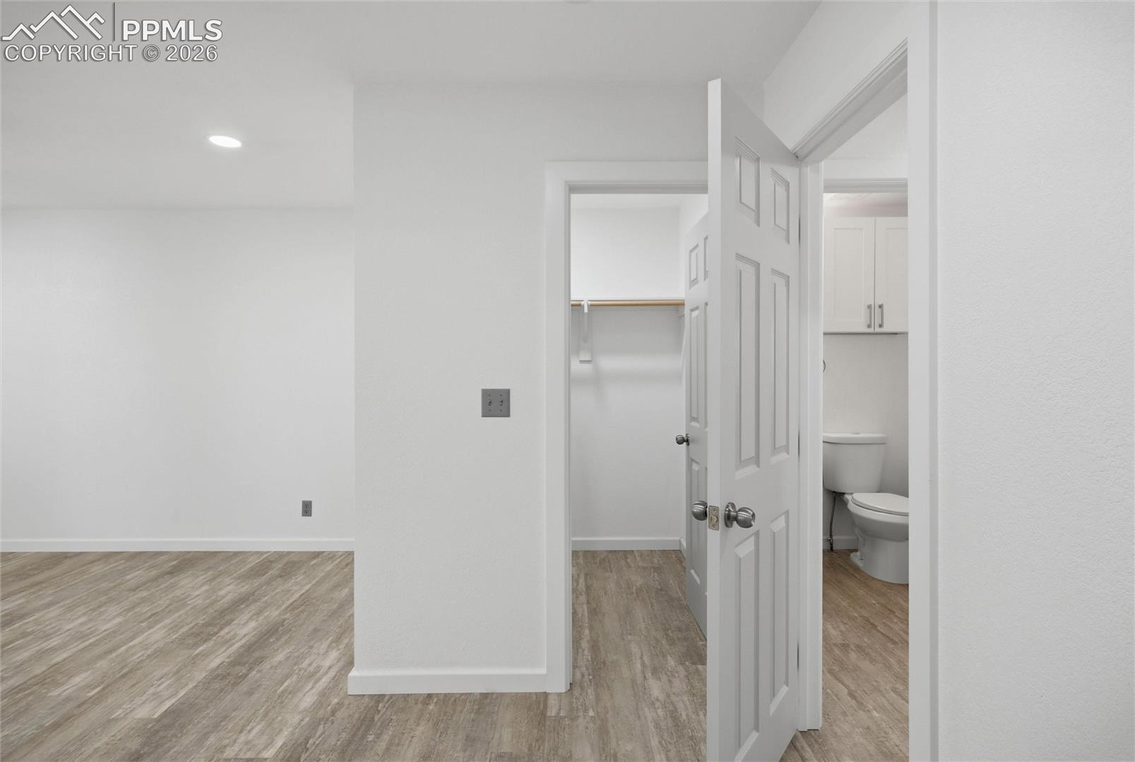 View into walk-iin closet & hall