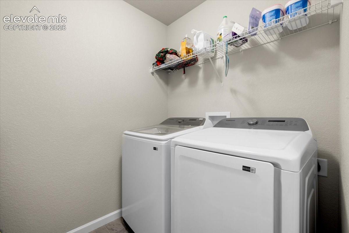 Laundry area with light neutral wall paint and wire shelving