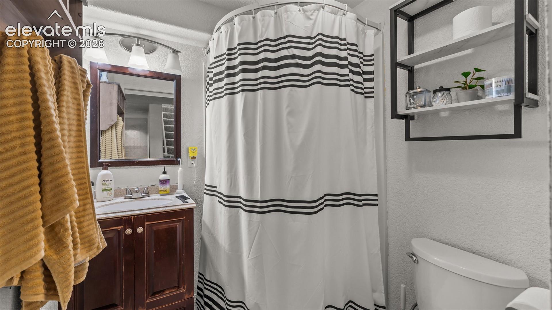 Dark wood-finish vanity with a built-in basin and framed mirror
