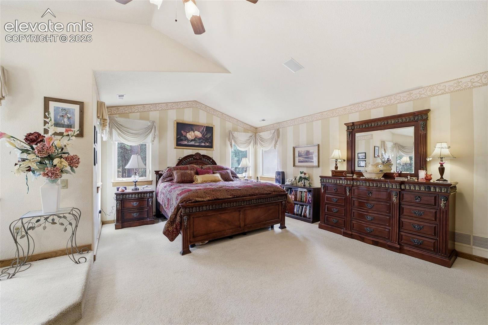 Primary Bedroom suite with vaulted ceilings and large walk in closet
