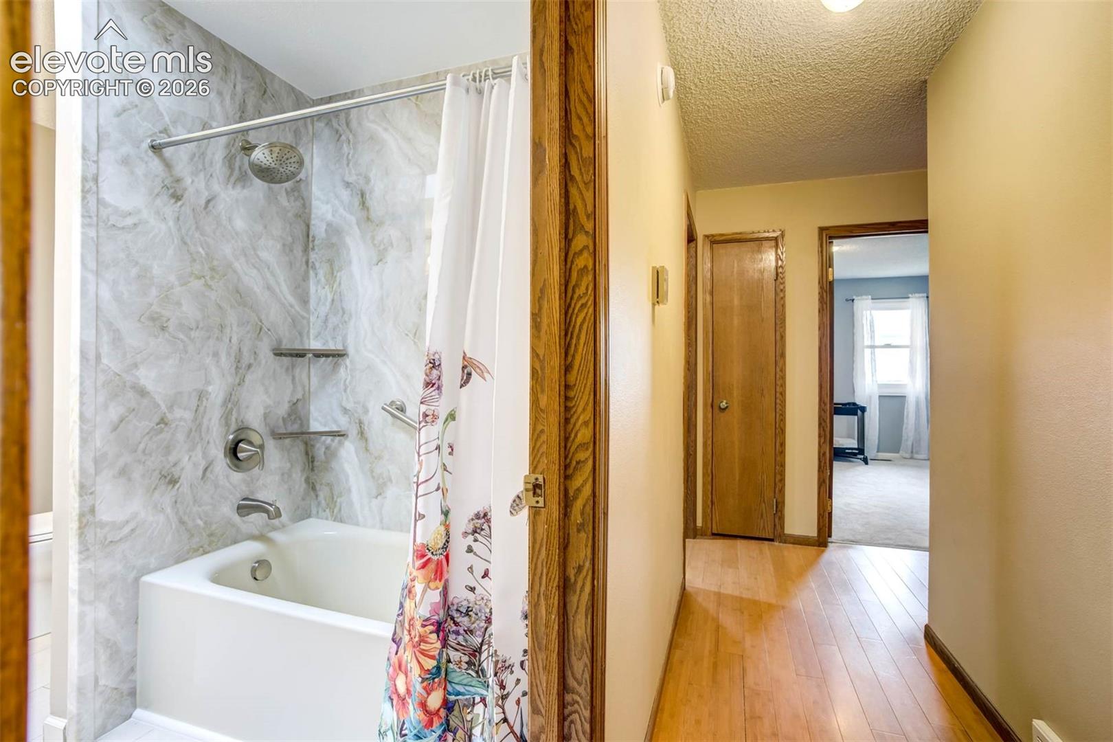 hall view: new full bath to left, linen closet, 3 bedrooms