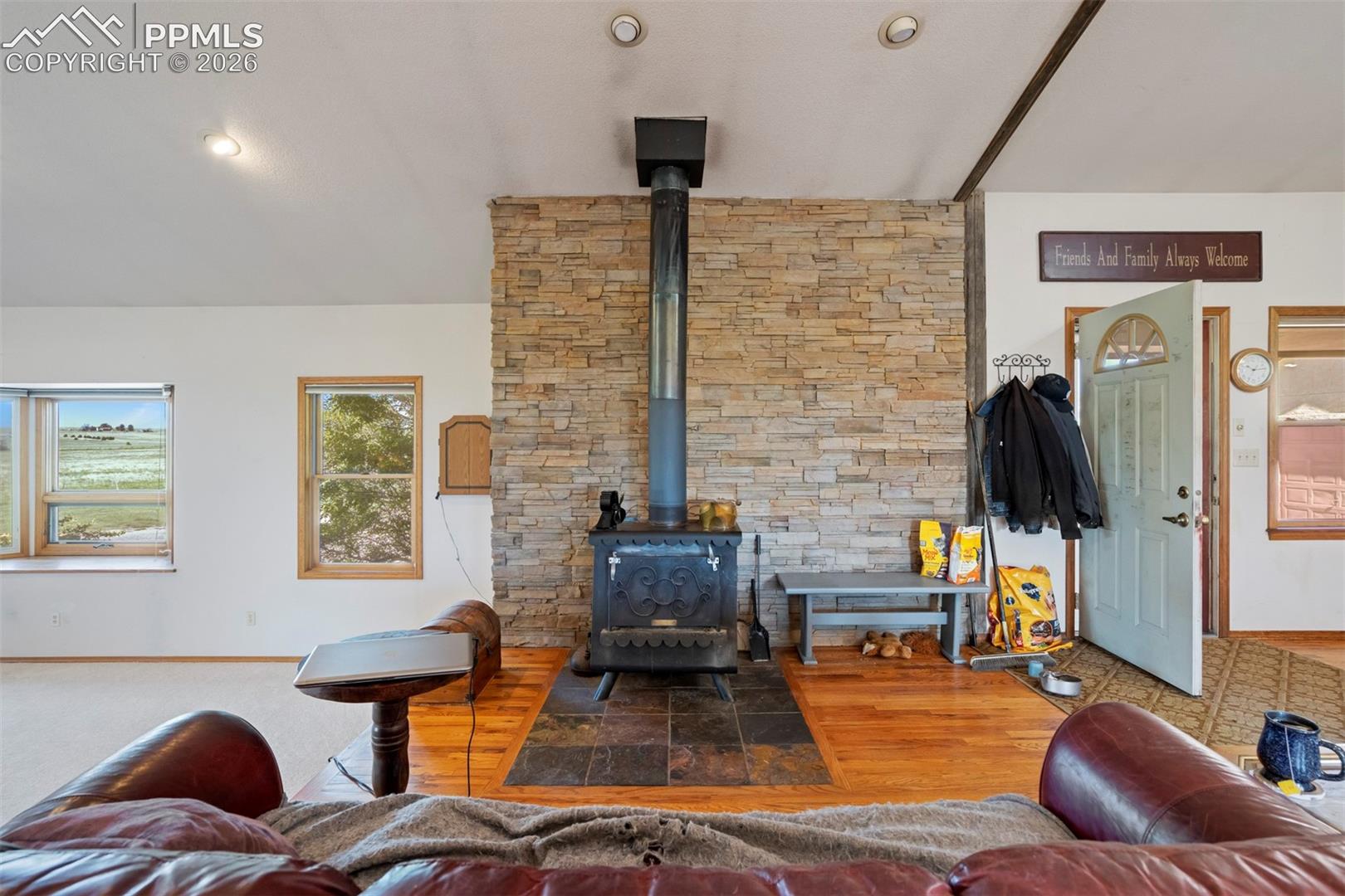 Central wood-burning stove featuring a stone surround and a slate hearth