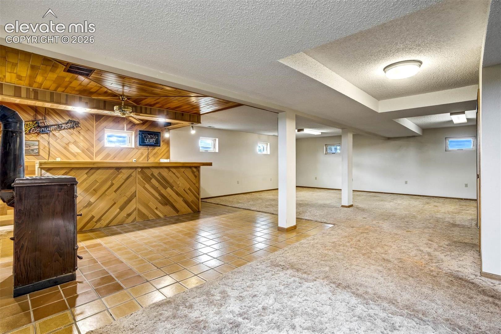wet bar, wood buring ceramic stove (can heat entire home), family room area