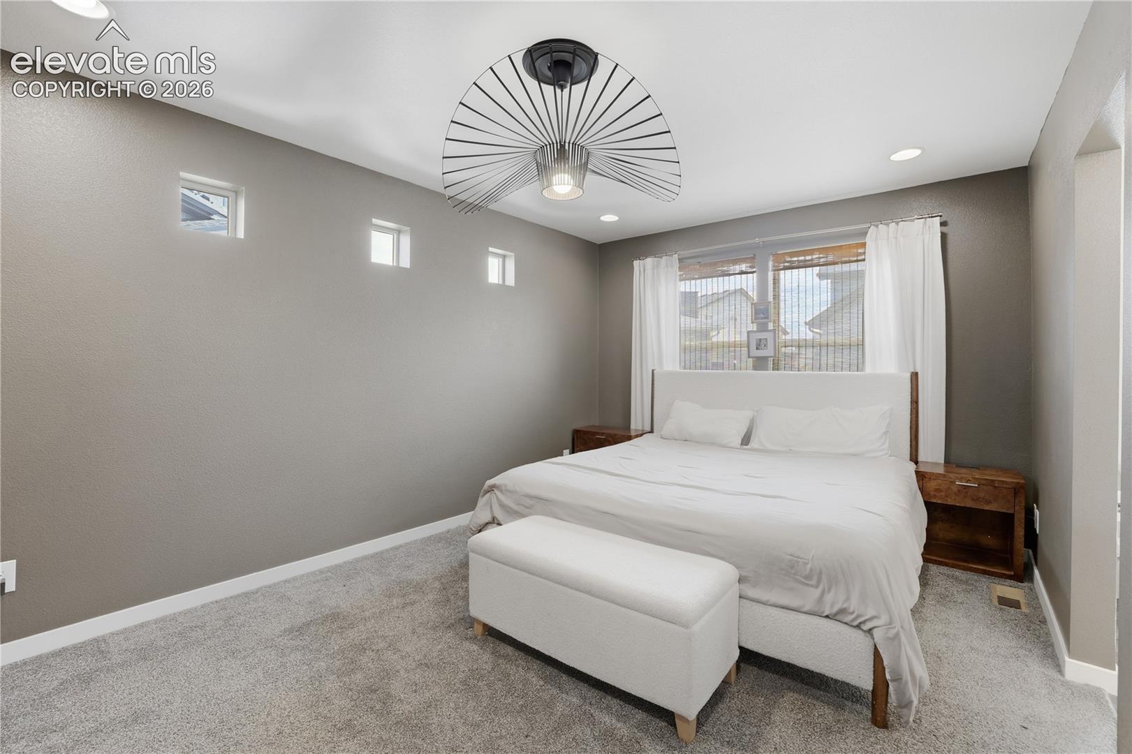 Spacious room featuring neutral-toned walls, recessed lighting, and a contemporary ceiling fan
