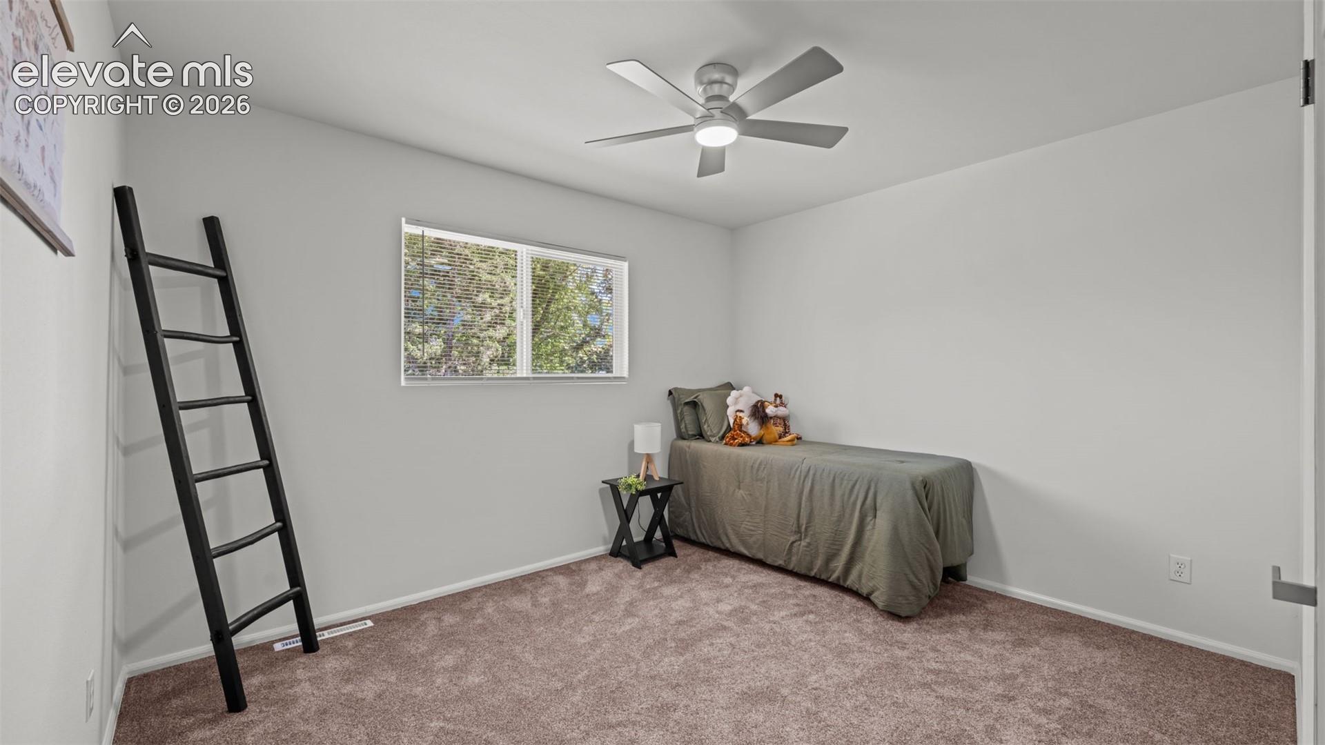 Recessed window, modern ceiling fan, and light-toned wall finishes
