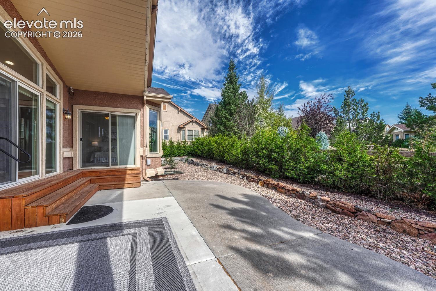 Slider from the Kitchen and also the Primary Bedroom to the partially covered backyard patio.