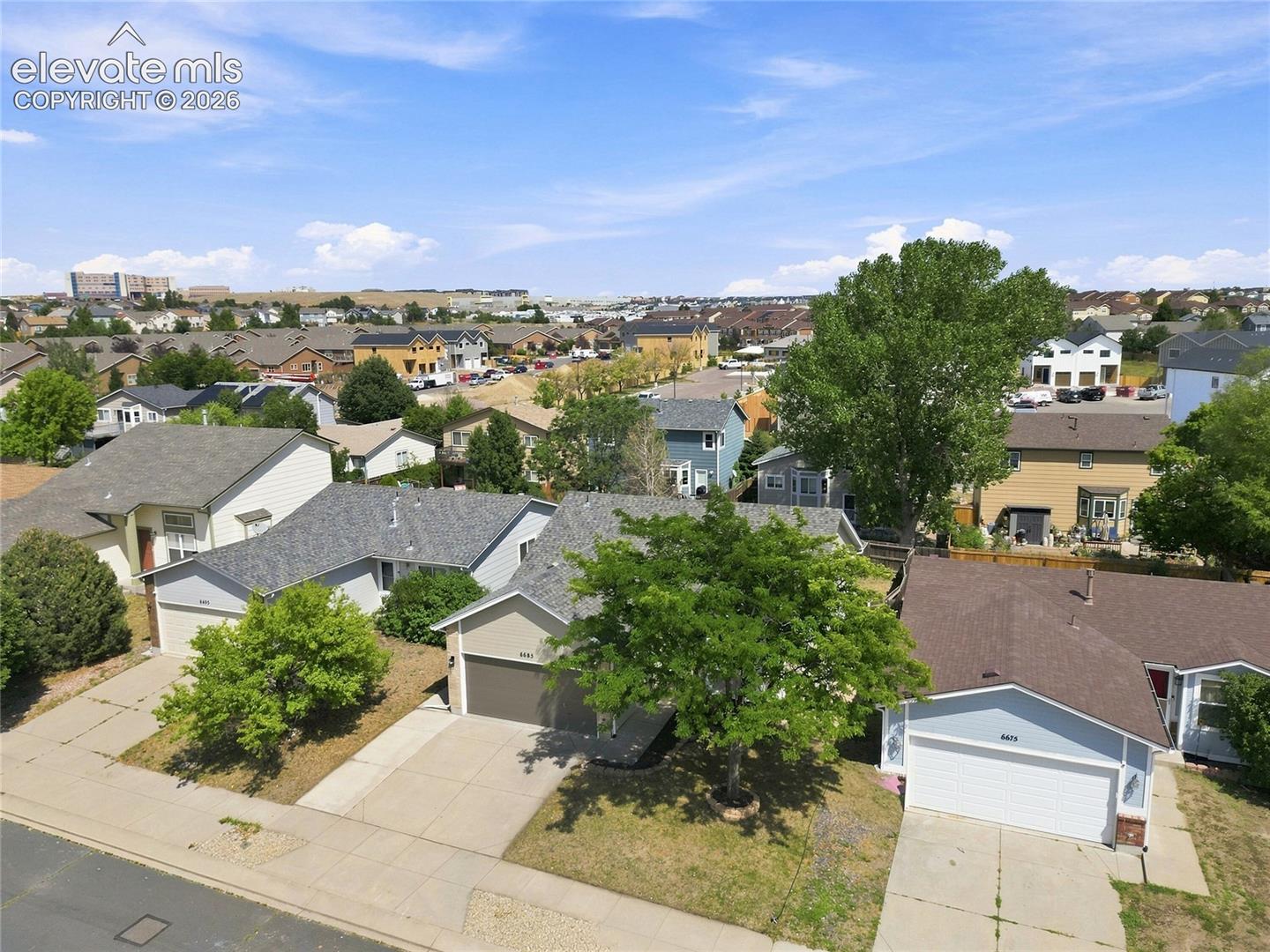 Neighborhood setting featuring residential properties and mature landscaping