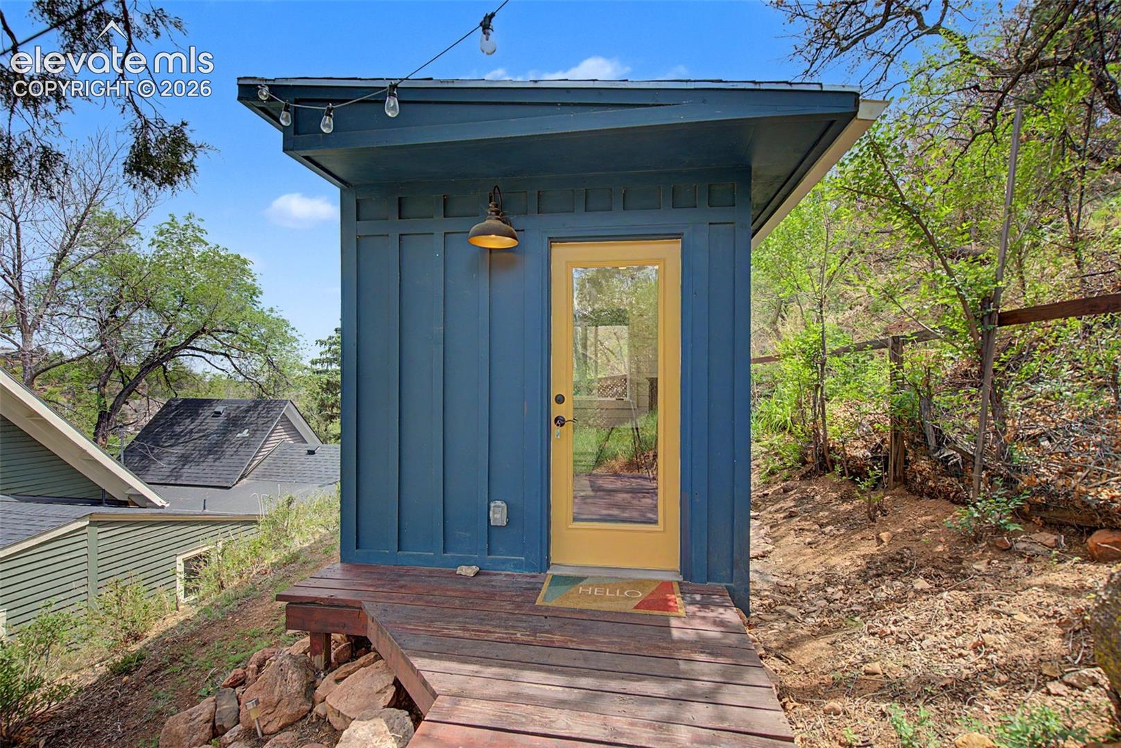 Creative studio entry in backyard with electricity and baseboard heating.