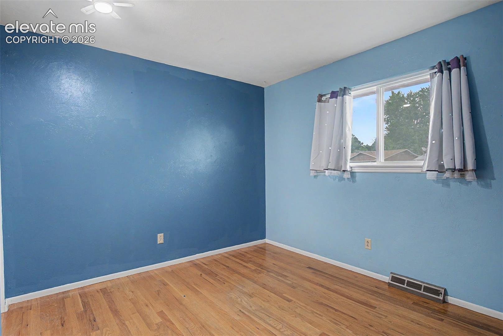 Secondary Bedroom with Hardwood Flooring